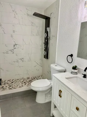 a bathroom with a sink toilet and shower