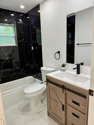 a bathroom with a sink a toilet and mirror