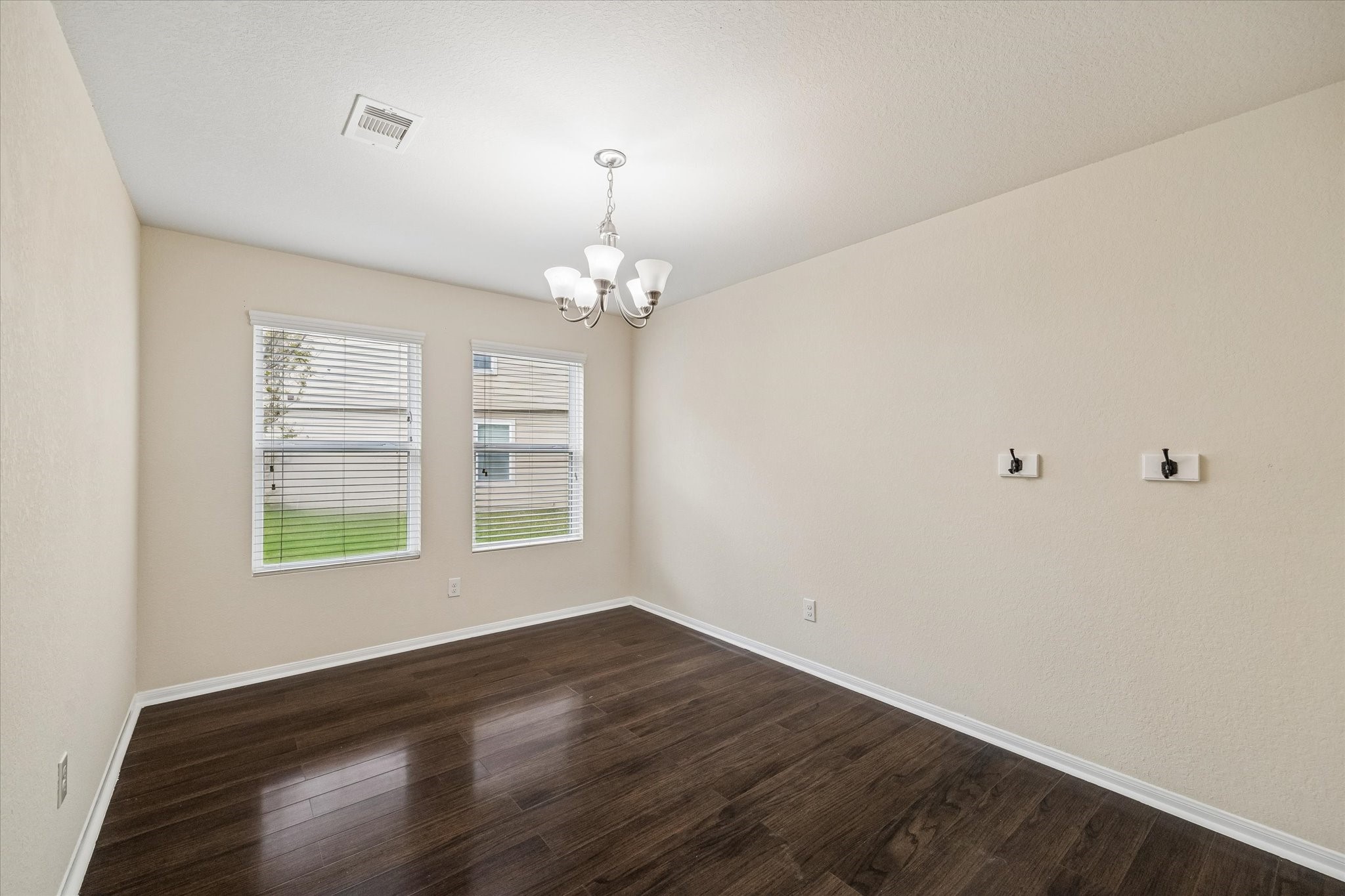 15642 South Fall Fern Circle Houston, TX 77044 - Photo 13 of 32 a view of an empty room with wooden floor and a window