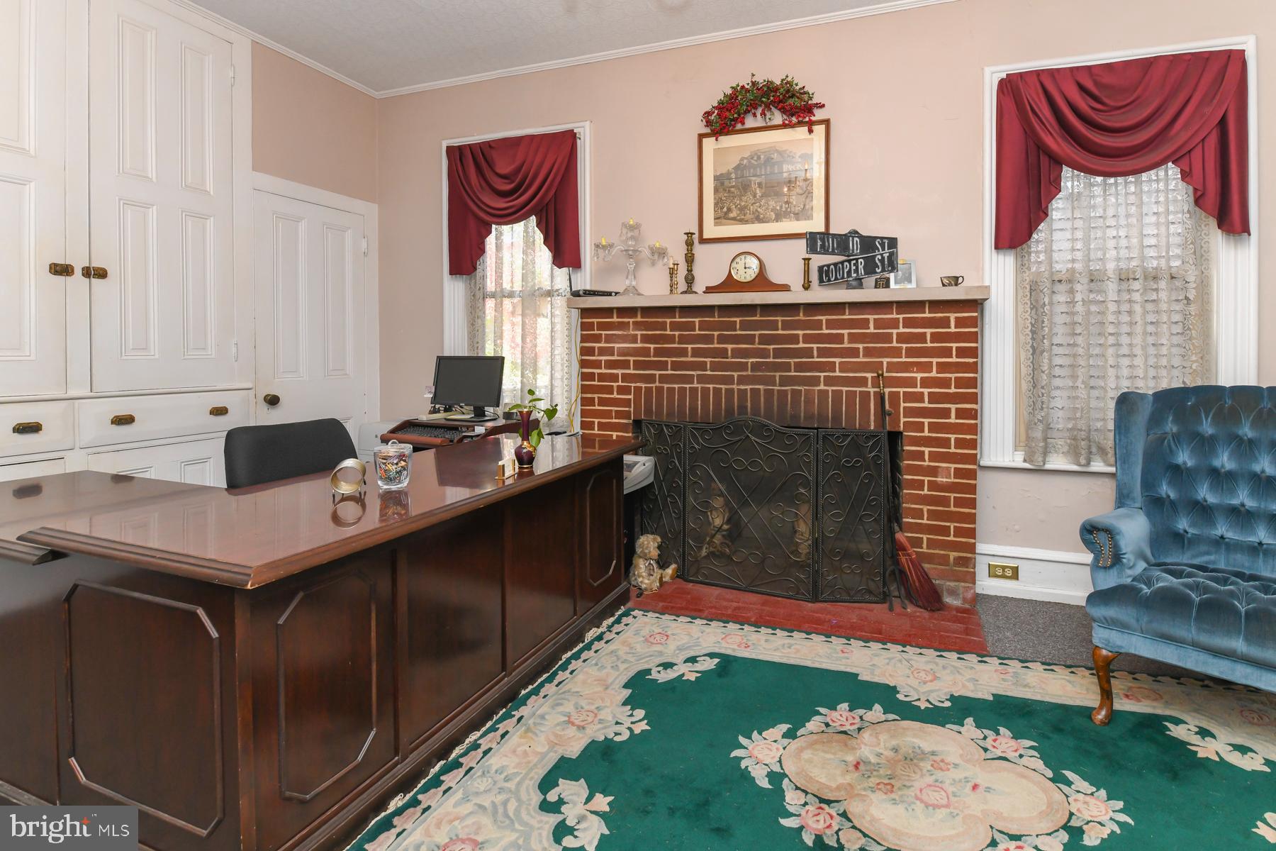 71 Cooper Street Woodbury, NJ 08096 - Photo 11 of 25 a living room with furniture a rug and a fireplace