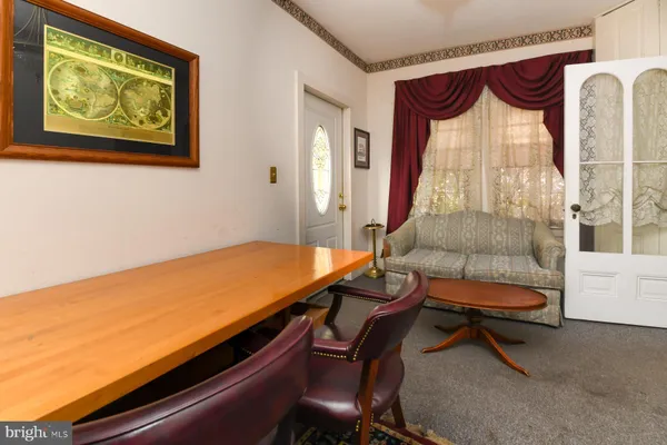 a dining room with furniture and window