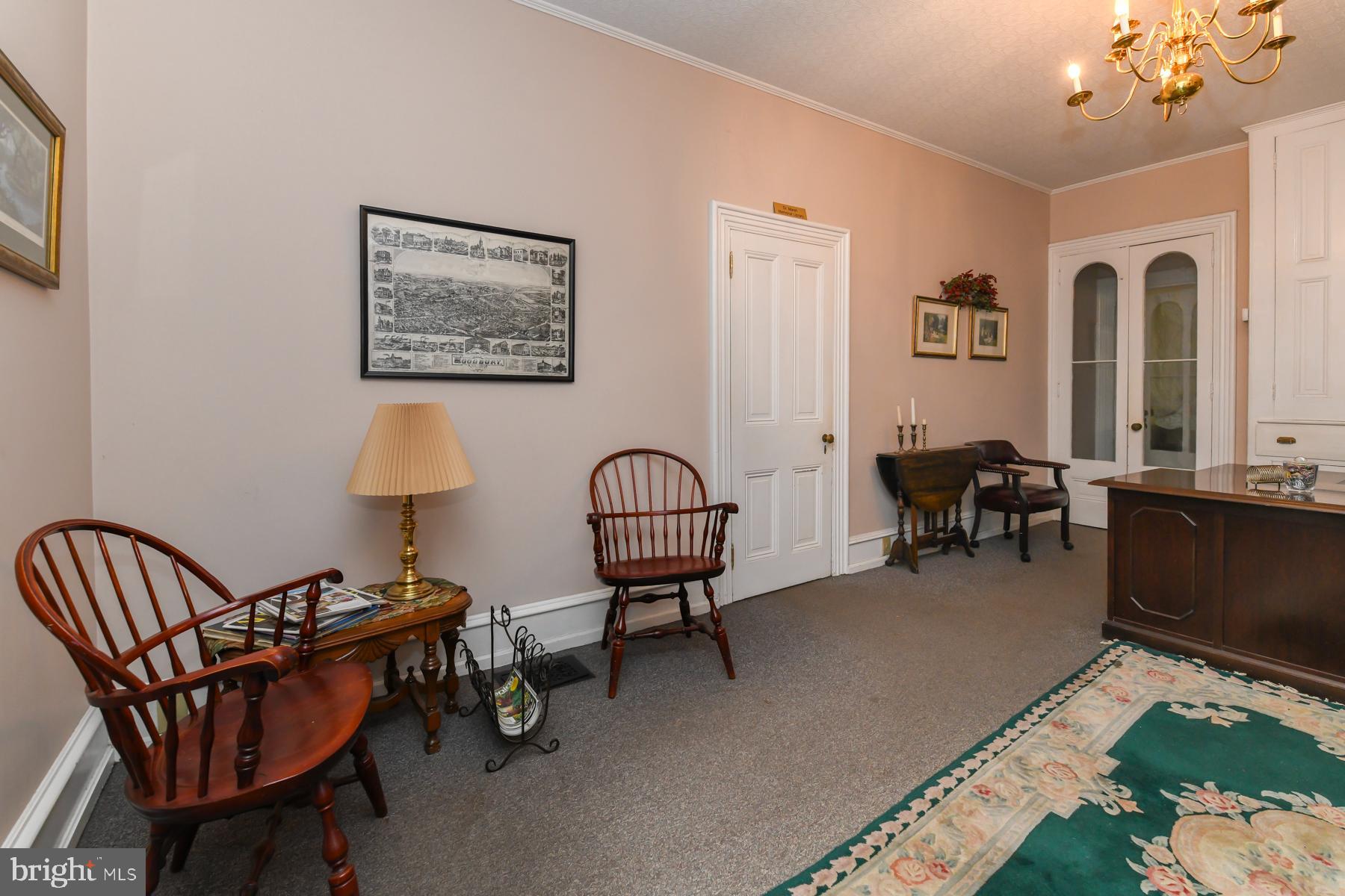71 Cooper Street Woodbury, NJ 08096 - Photo 8 of 25 a living room with furniture a rug and a chandelier