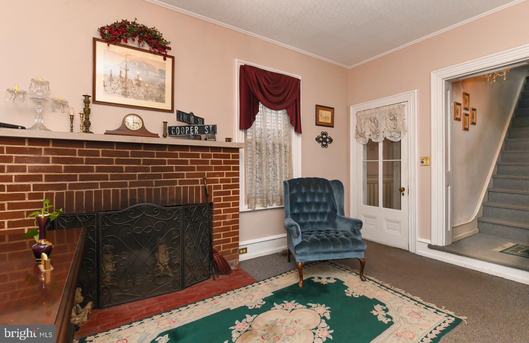 71 Cooper Street Woodbury, NJ 08096 - Photo 9 of 25 a living room with furniture and a fireplace