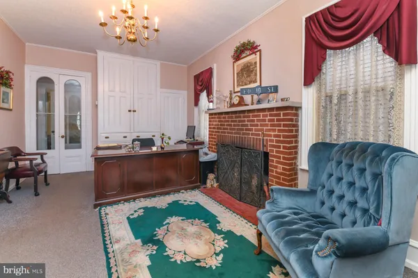 a living room with furniture a rug and a fireplace