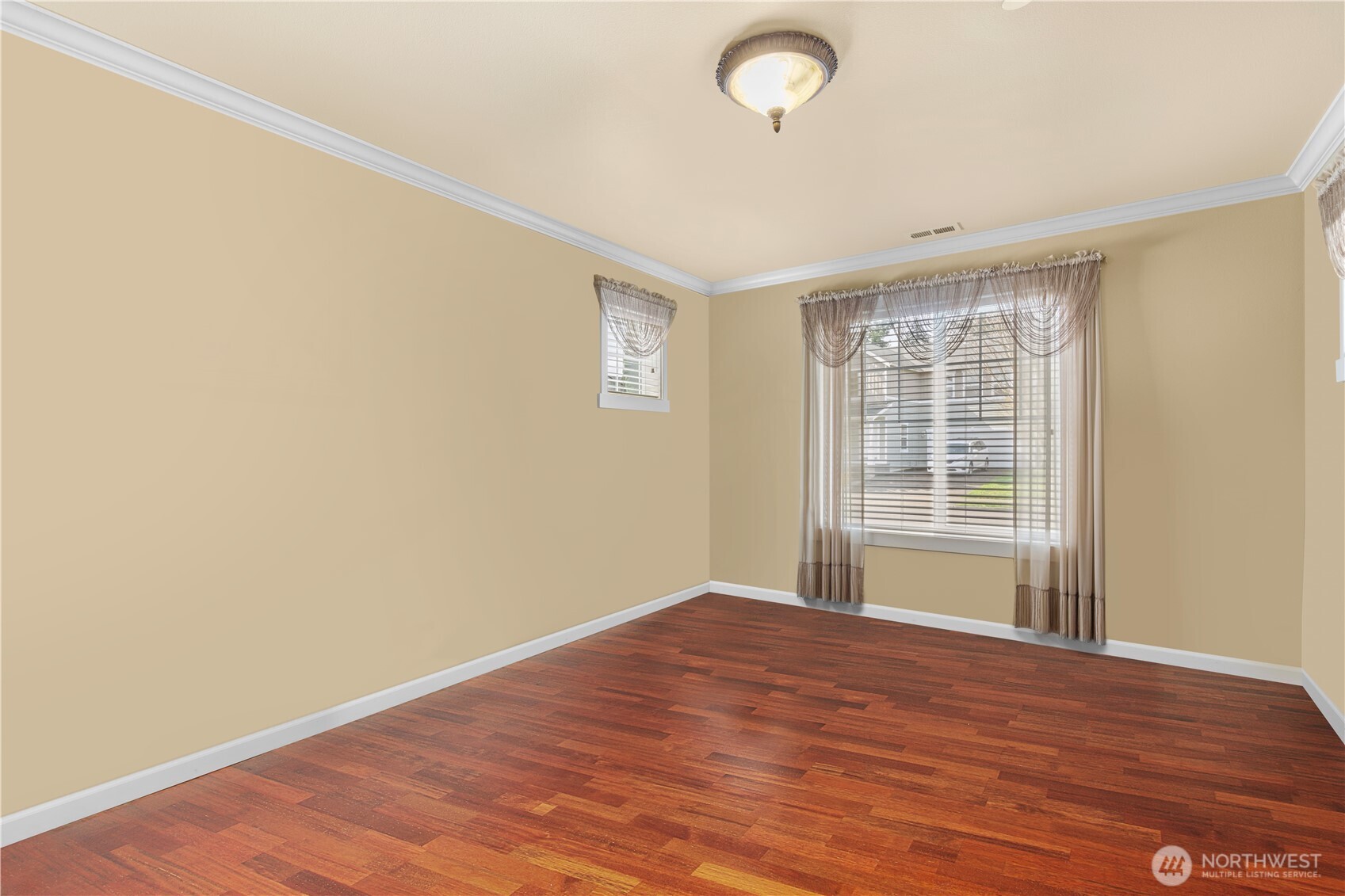 1375 Foreman Road DuPont, WA 98327 - Photo 5 of 30 an empty room with wooden floor and windows