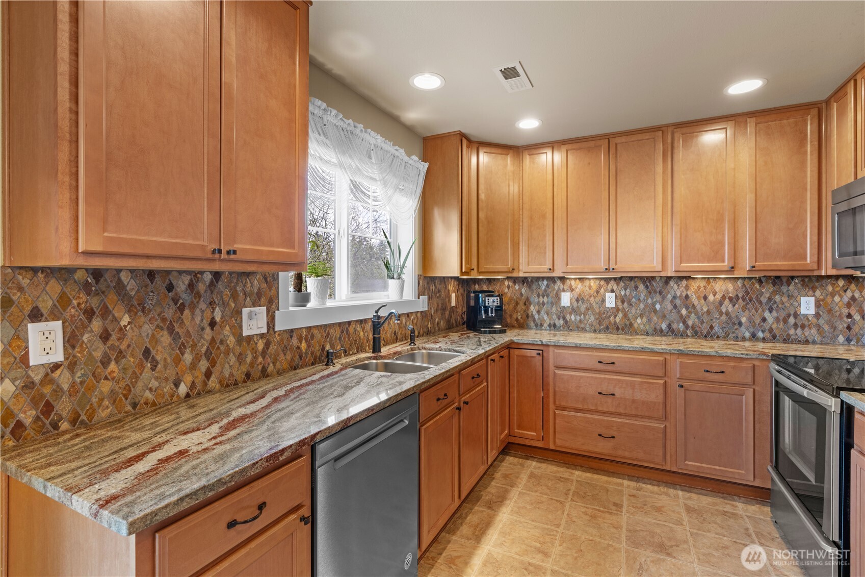1375 Foreman Road DuPont, WA 98327 - Photo 10 of 30 a kitchen with sink cabinets and window