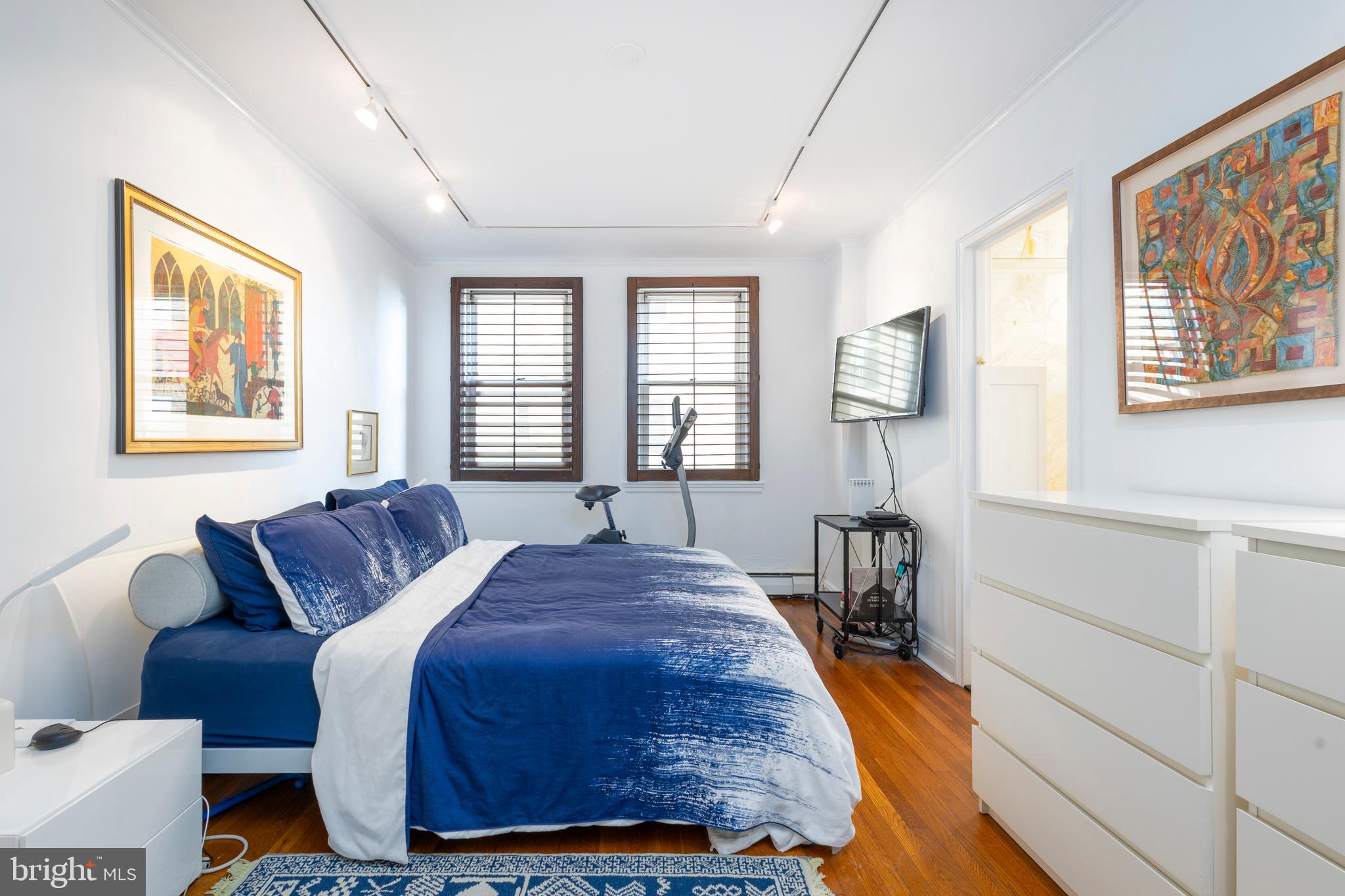 1901 Walnut Street, Unit 15B Philadelphia, PA 19103 - Photo 21 of 36 a bed sitting in a bedroom next to a window