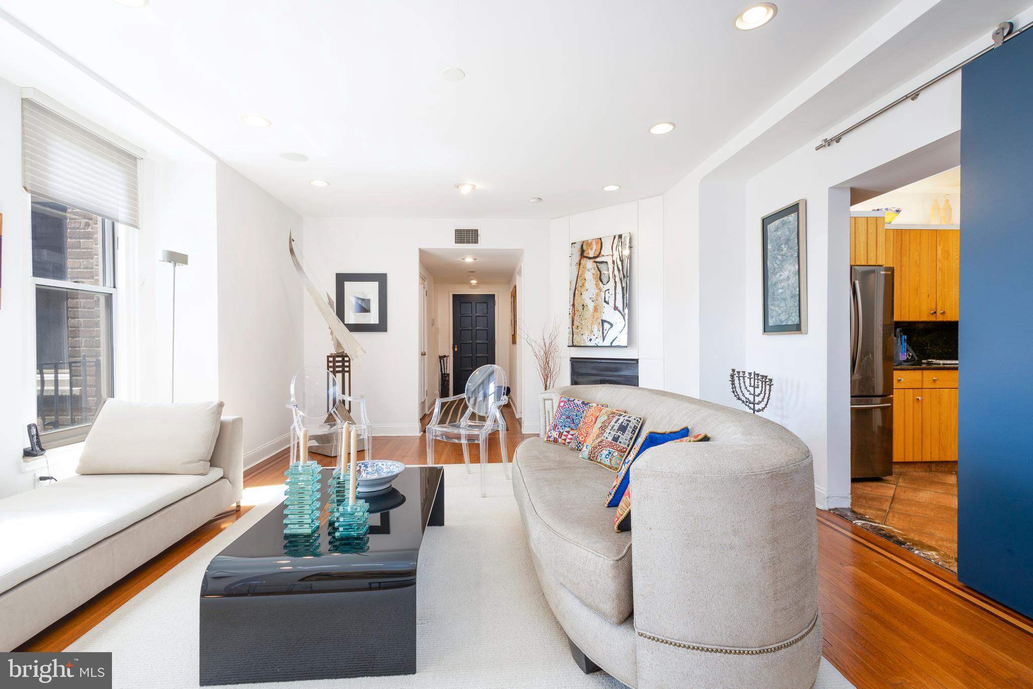 1901 Walnut Street, Unit 15B Philadelphia, PA 19103 - Photo 6 of 36 a living room with furniture and a table