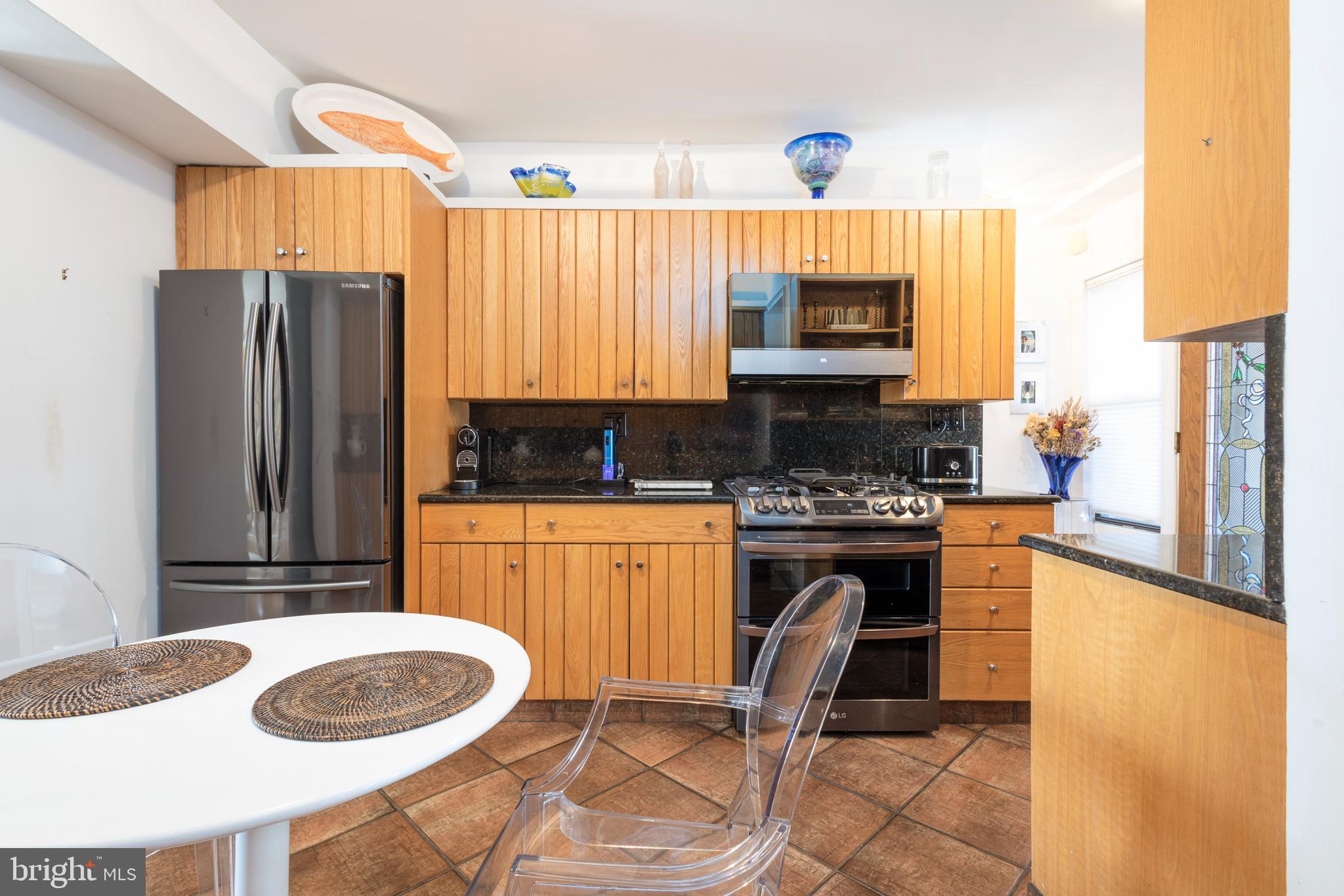 1901 Walnut Street, Unit 15B Philadelphia, PA 19103 - Photo 9 of 36 a kitchen with a refrigerator and a stove top oven