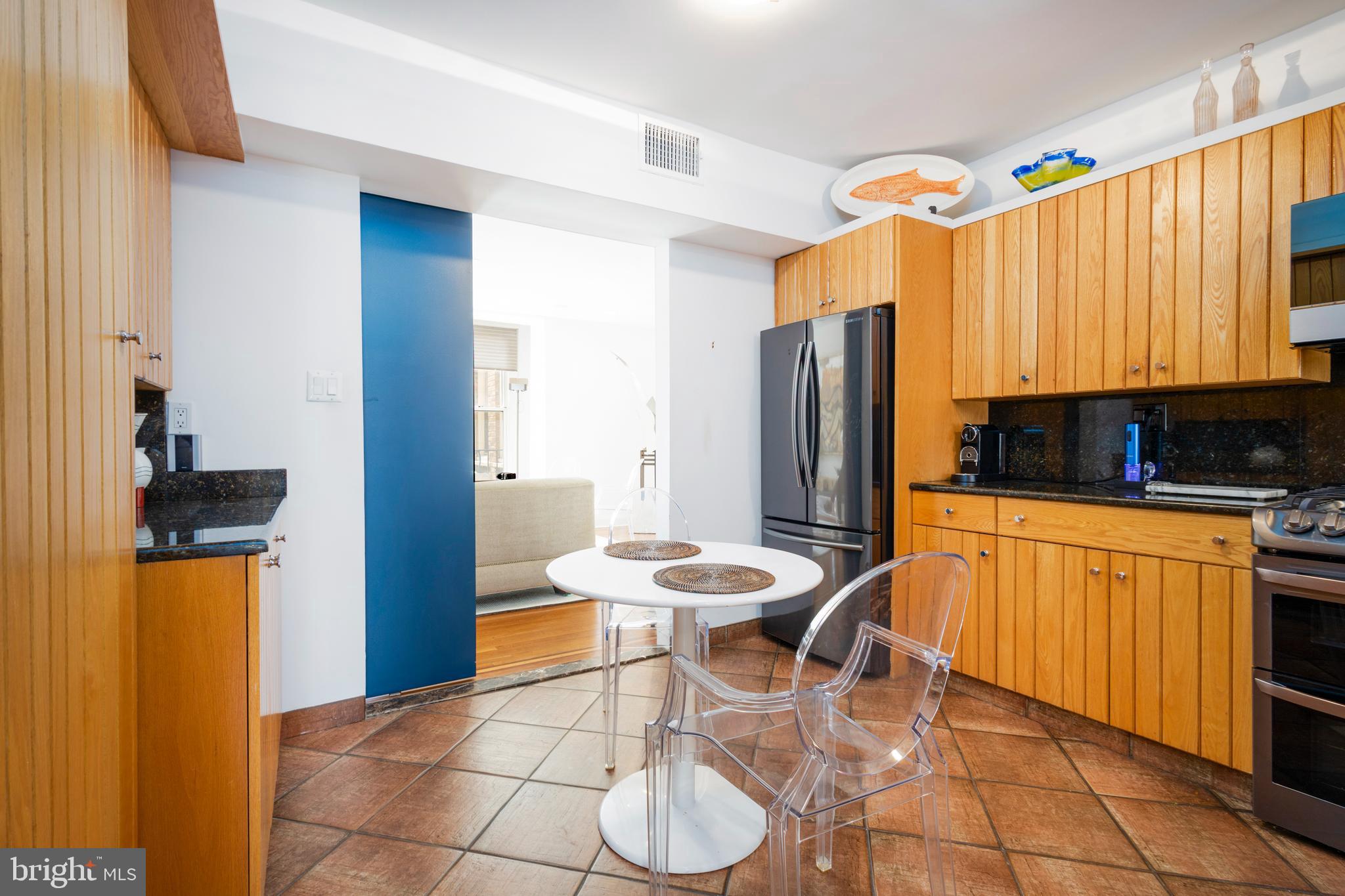 1901 Walnut Street, Unit 15B Philadelphia, PA 19103 - Photo 10 of 36 a kitchen with stainless steel appliances granite countertop a refrigerator and a stove top oven