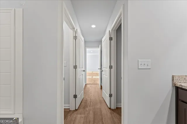 a view of hallway with wooden floor