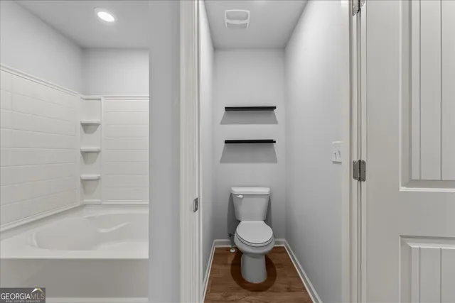 a bathroom with a toilet and a bathtub