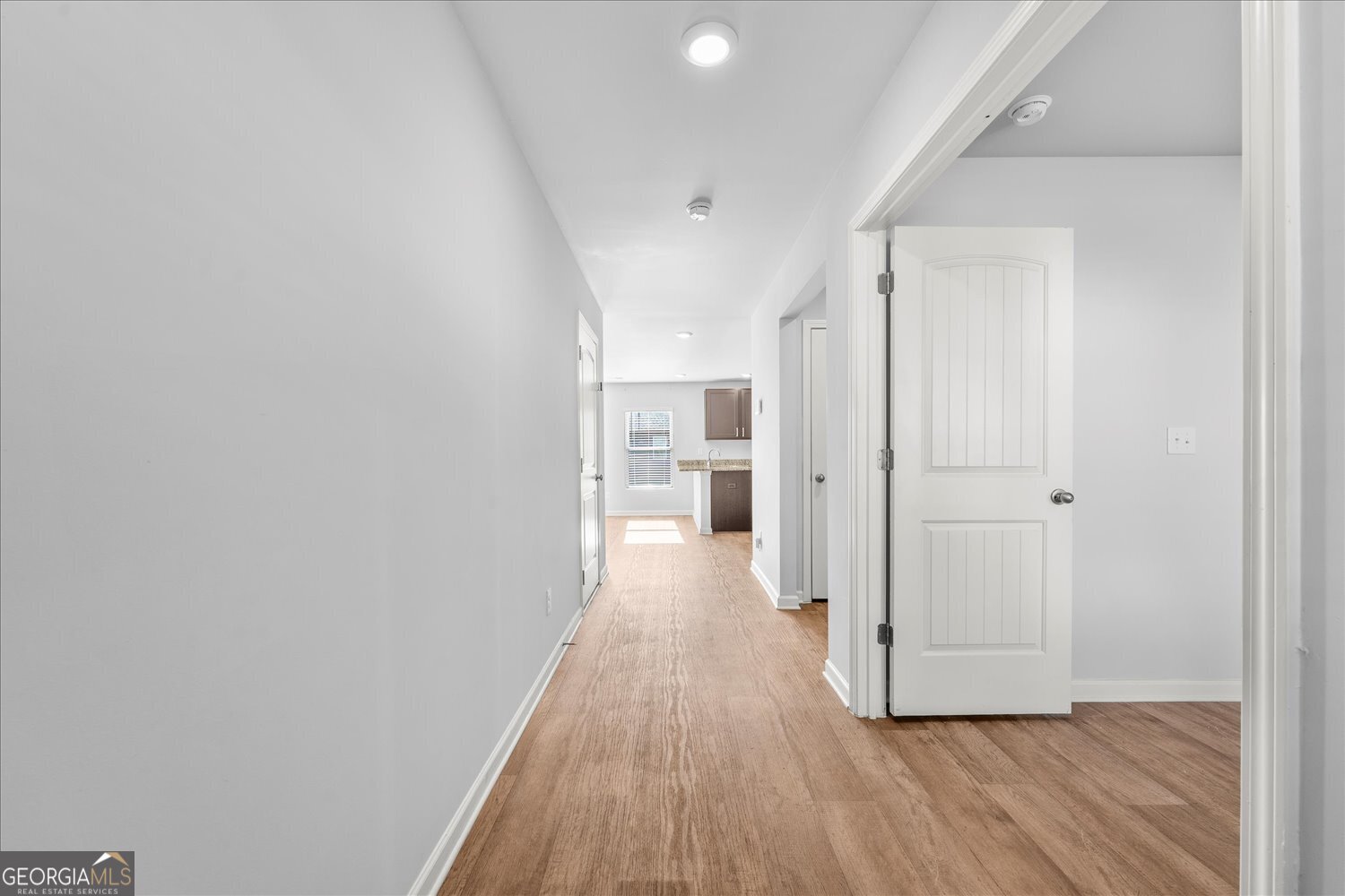 89 Cowpen Court Covington, GA 30014 - Photo 4 of 44 a view of a hallway with wooden floor and a bathroom
