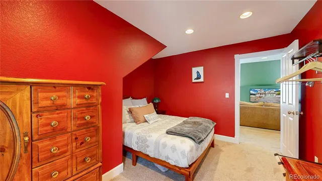 a bedroom with a bed and a dresser