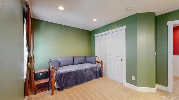 a living room with a couch and a dresser with wooden floor