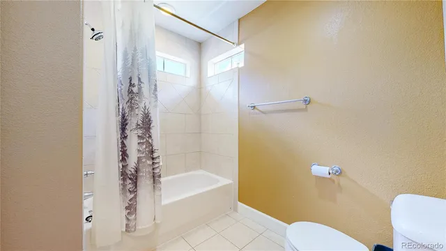 a bathroom with a sink a toilet a bathtub and shower