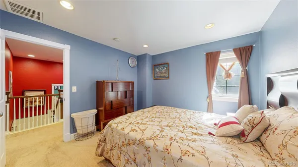 a bedroom with a bed and dresser with mirror