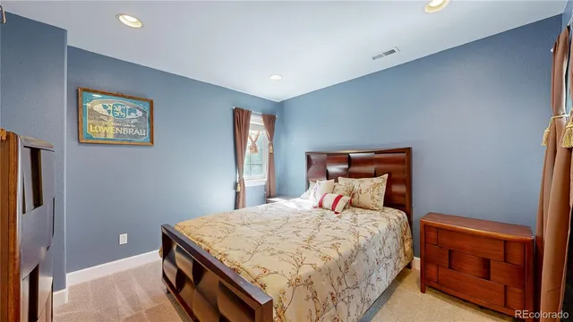 a bed sitting in a bedroom next to a window