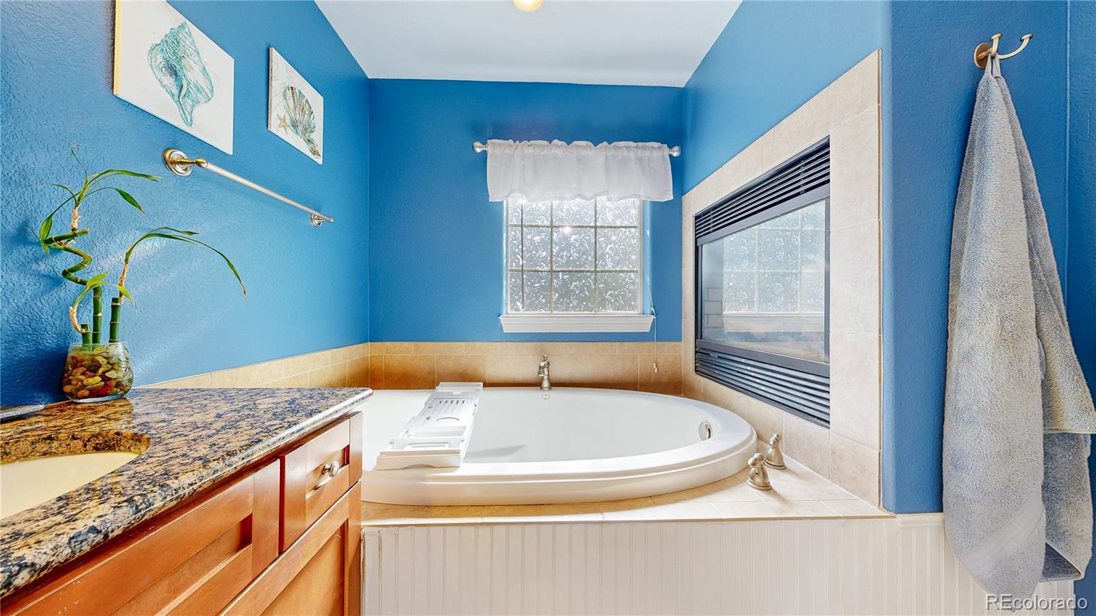1431 Marion Street Georgetown, CO 80444 - Photo 22 of 50 a bathroom with a granite countertop sink and a bathtub
