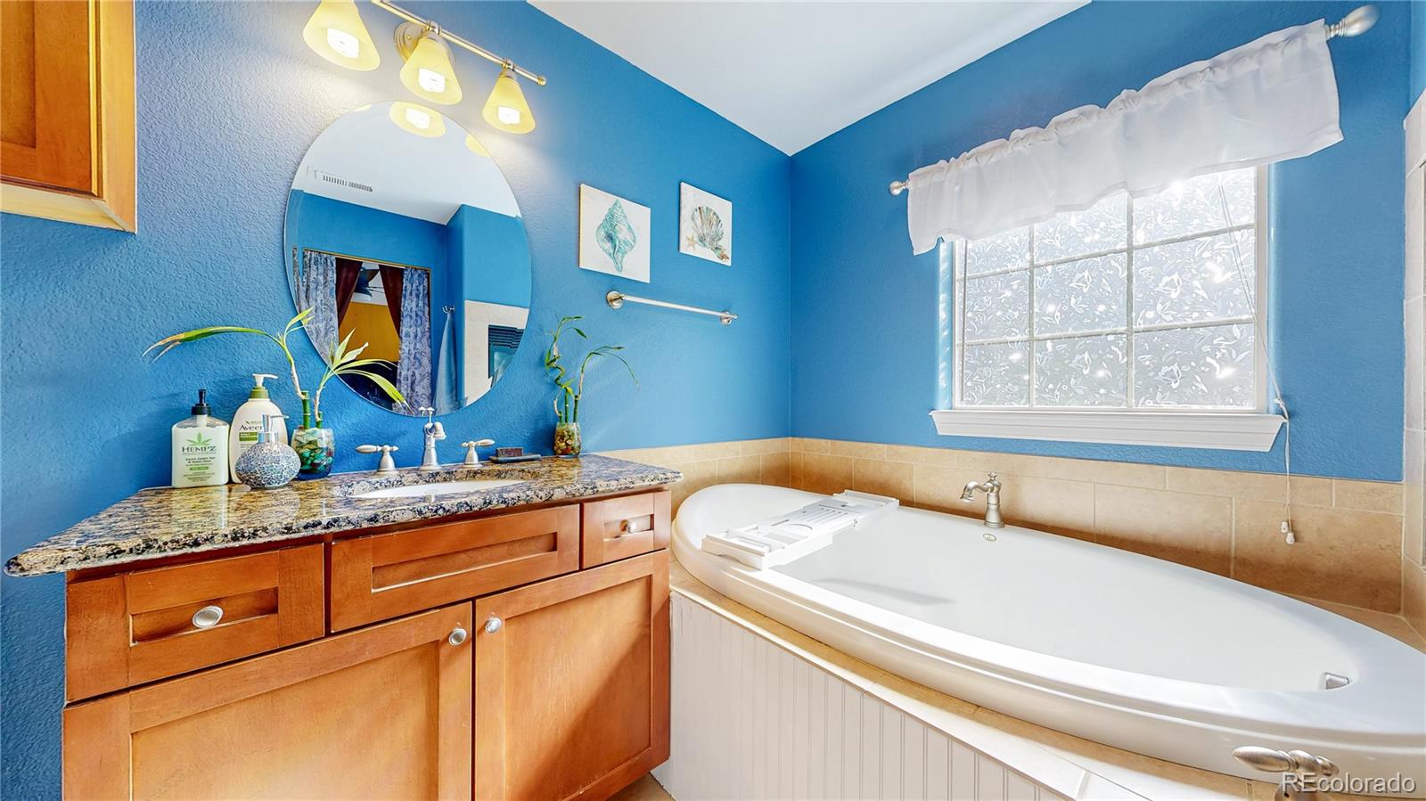1431 Marion Street Georgetown, CO 80444 - Photo 23 of 50 a bathroom with a granite countertop sink and a large mirror