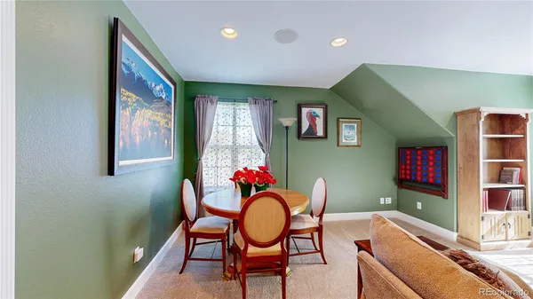 a living room with furniture and flowers