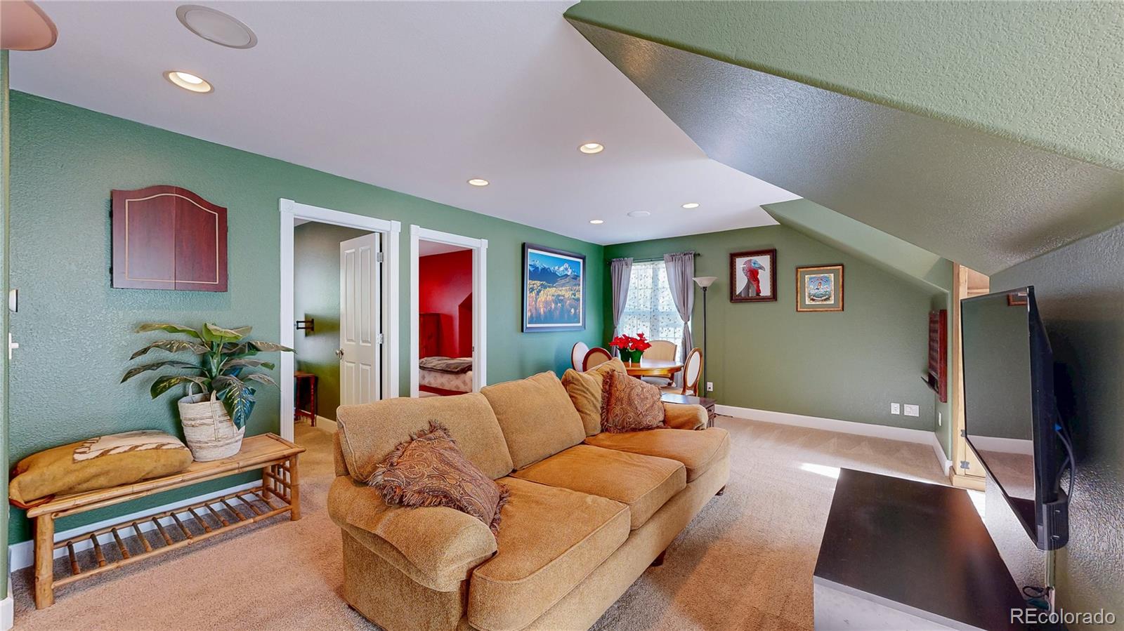 1431 Marion Street Georgetown, CO 80444 - Photo 32 of 50 a living room with furniture and a flat screen tv