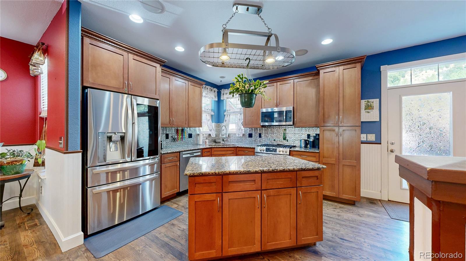 1431 Marion Street Georgetown, CO 80444 - Photo 41 of 50 a kitchen with stainless steel appliances granite countertop a refrigerator a sink dishwasher a stove and white countertops with wooden floor