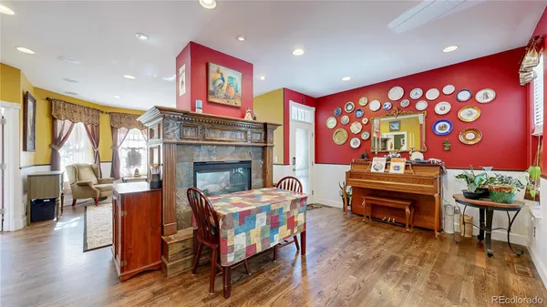 a living room with fireplace furniture and a rug
