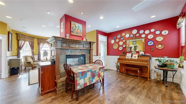 a living room with fireplace furniture and a rug