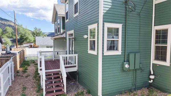 a backyard of a house with table and chairs