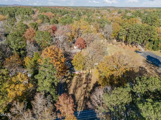 a view of a yard with wooden fence