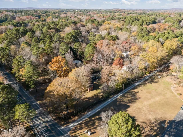 an aerial view of house with yard and mountain view in back