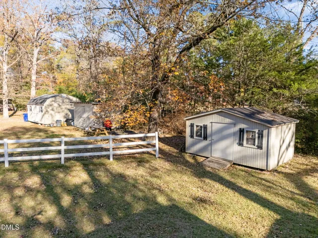 a view of a house with a yard covered in snow