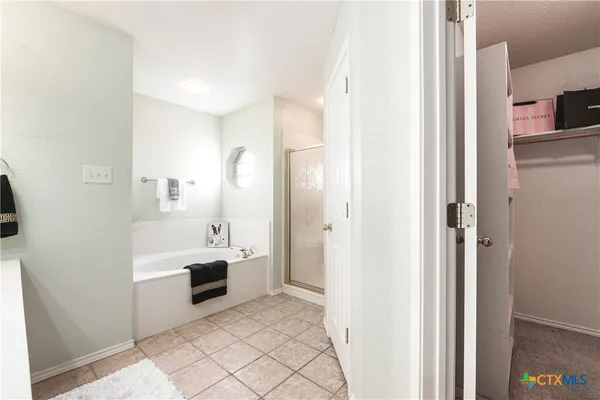 a bathroom with a sink a toilet a mirror and shower