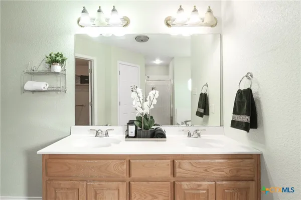 a bathroom with a sink vanity and a mirror