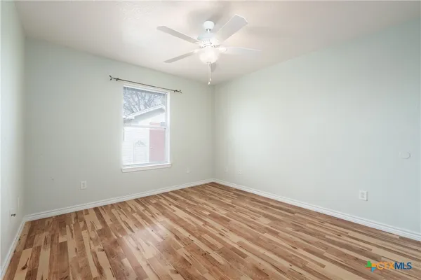 wooden floor in an empty room with a window