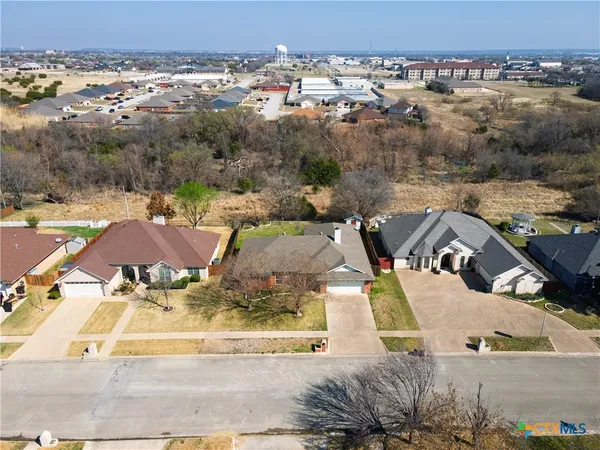 an aerial view of a house with a yard