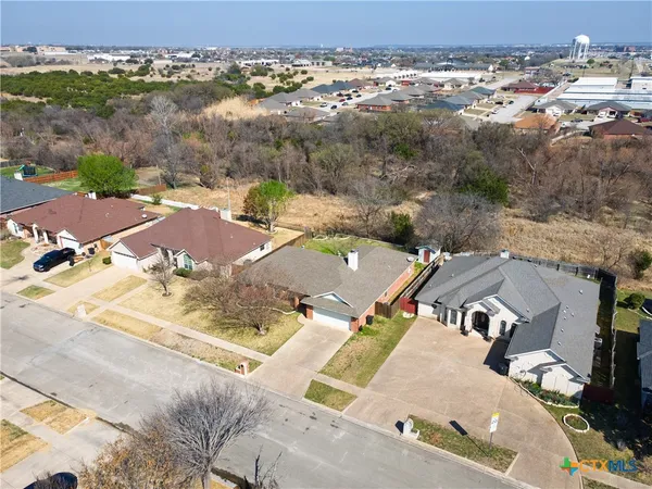 an aerial view of residential houses with outdoor space