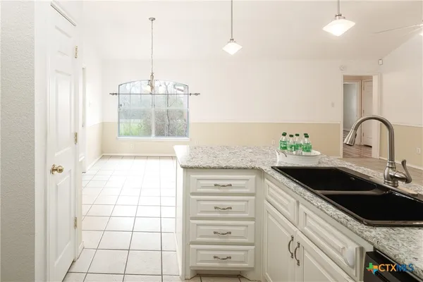 a kitchen with a sink and a refrigerator