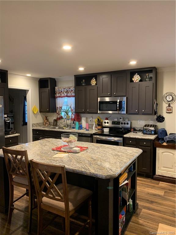 170 Austin Circle Rutherfordton, NC 28139 - Photo 4 of 11 a kitchen with stainless steel appliances granite countertop a table chairs sink refrigerator and microwave