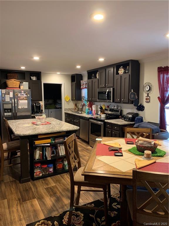170 Austin Circle Rutherfordton, NC 28139 - Photo 5 of 11 a kitchen with stainless steel appliances kitchen island granite countertop a table chairs and a stove