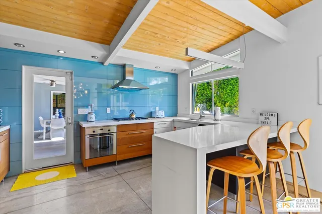 a large kitchen with stainless steel appliances granite countertop a sink and cabinets