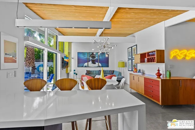 a room with wooden cabinets and dining table