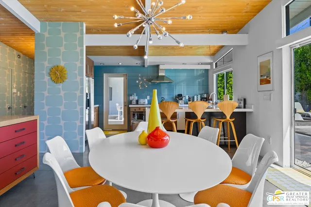 a view of a dining room with furniture a chandelier and wooden floor