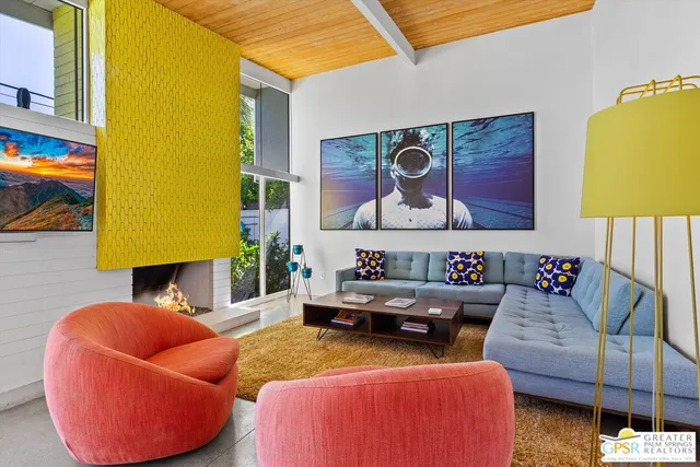 a living room with furniture and a lamp