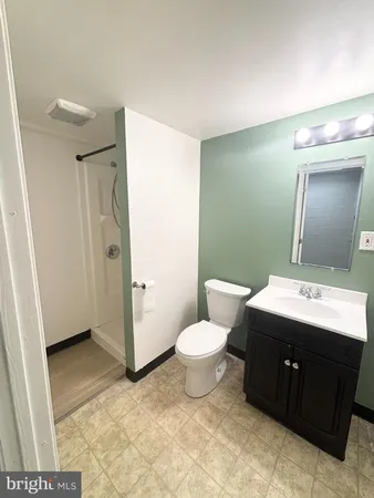 a bathroom with a sink toilet and mirror