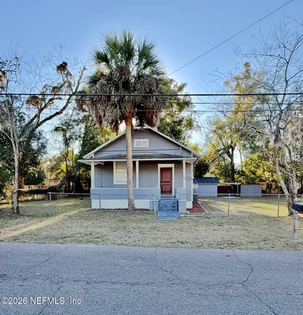 a house that has a tree in front of it