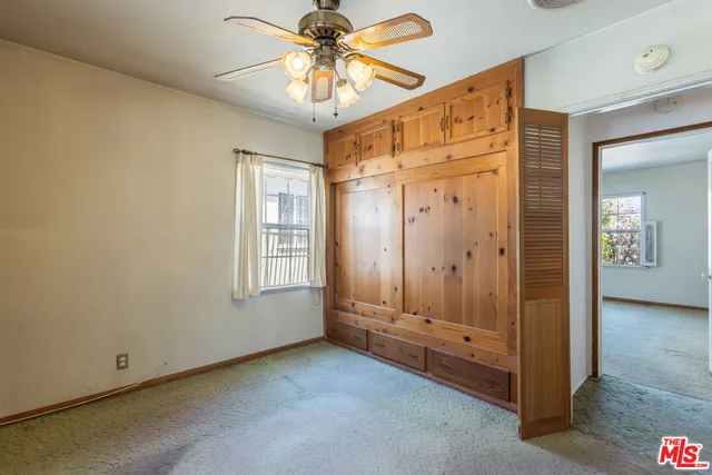 a bathroom with a granite countertop toilet sink and mirror