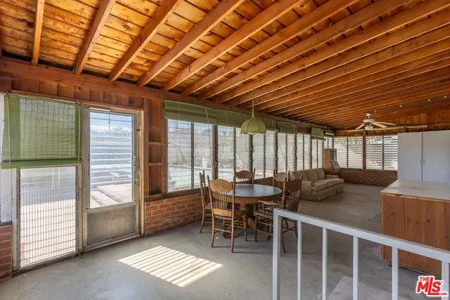 a view of a patio with table and chairs