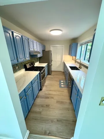 a view of entryway room and wooden floor